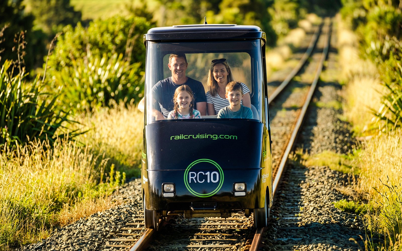 Family enjoying a self-drive rail car journey in Ngongotaha, New Zealand.