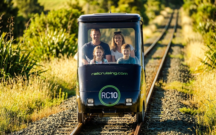 Family enjoying a self-drive rail car journey in Ngongotaha, New Zealand.