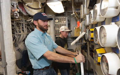 Men operating machinery during a guided engineering tour.