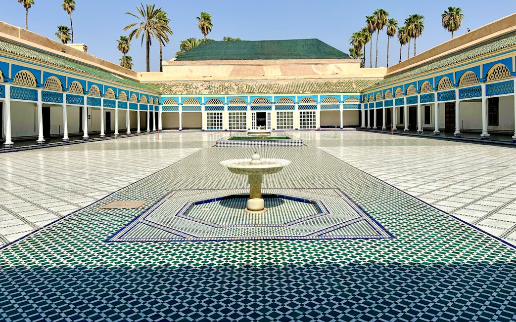 Bahia Palace courtyard with fountain and colorful tilework in Marrakech, Morocco.
