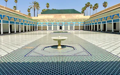 Bahia Palace courtyard with fountain and colorful tilework in Marrakech, Morocco.
