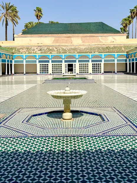 Bahia Palace courtyard with fountain and colorful tilework in Marrakech, Morocco.