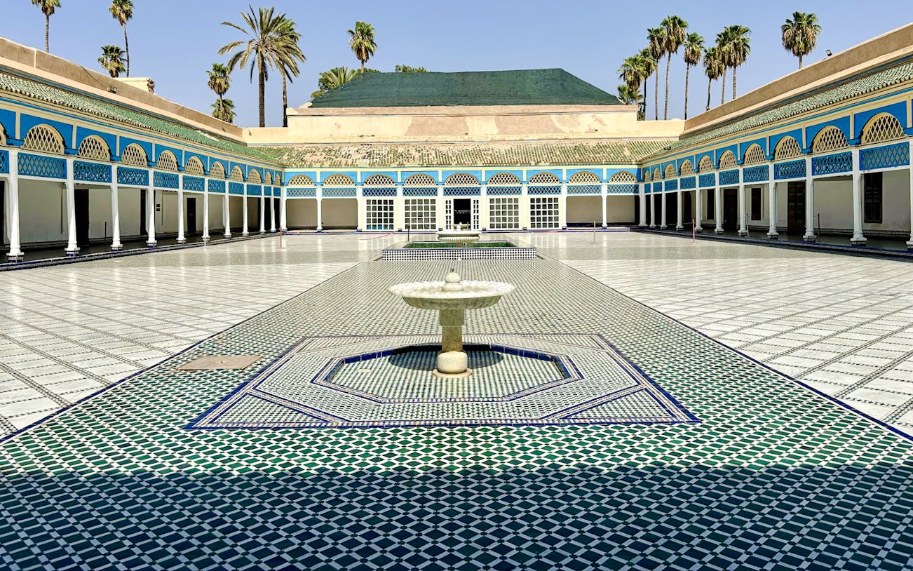 Bahia Palace courtyard with fountain and colorful tilework in Marrakech, Morocco.