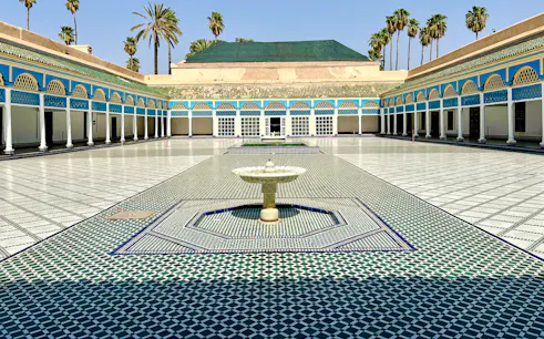 Bahia Palace courtyard with fountain and colorful tilework in Marrakech, Morocco.