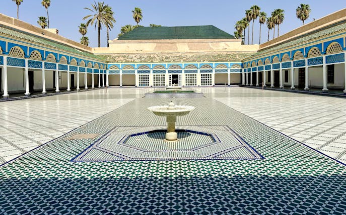 Bahia Palace courtyard with fountain and colorful tilework in Marrakech, Morocco.