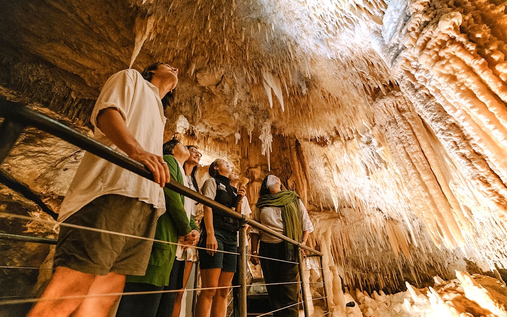 Visitors exploring stalactites in Jewel Cave, Margaret River guided tour.