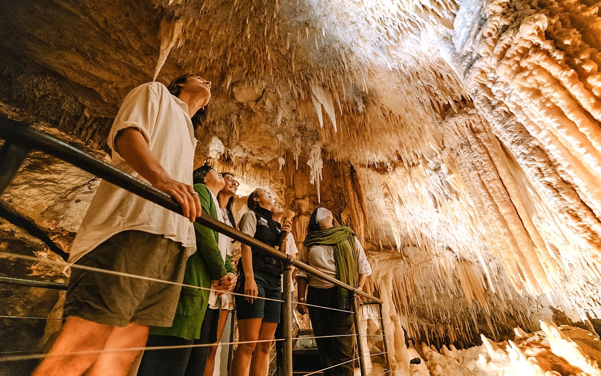 Visitors exploring stalactites in Jewel Cave, Margaret River guided tour.