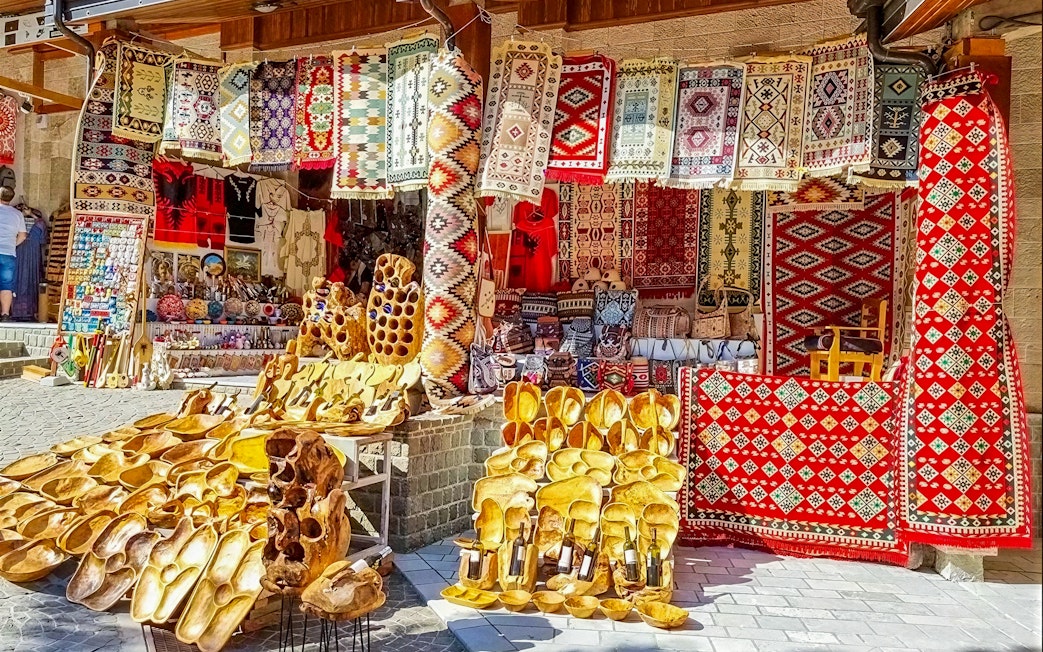 Colorful rugs and wooden crafts displayed at Old Bazaar, Kruje city, Albania.