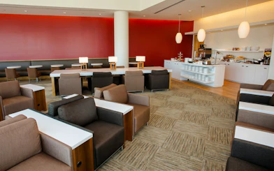 Seating area and buffet at Plaza Premium Lounge, Terminal 3, Toronto Pearson Airport.