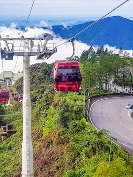 Genting Highlands cable car ascending through lush green hills.