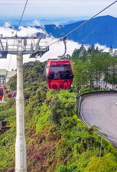 Genting Highlands cable car ascending through lush green hills.