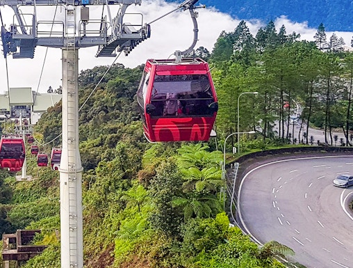 Genting Highlands cable car ascending through lush green hills.