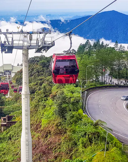Genting Highlands cable car ascending through lush green hills.