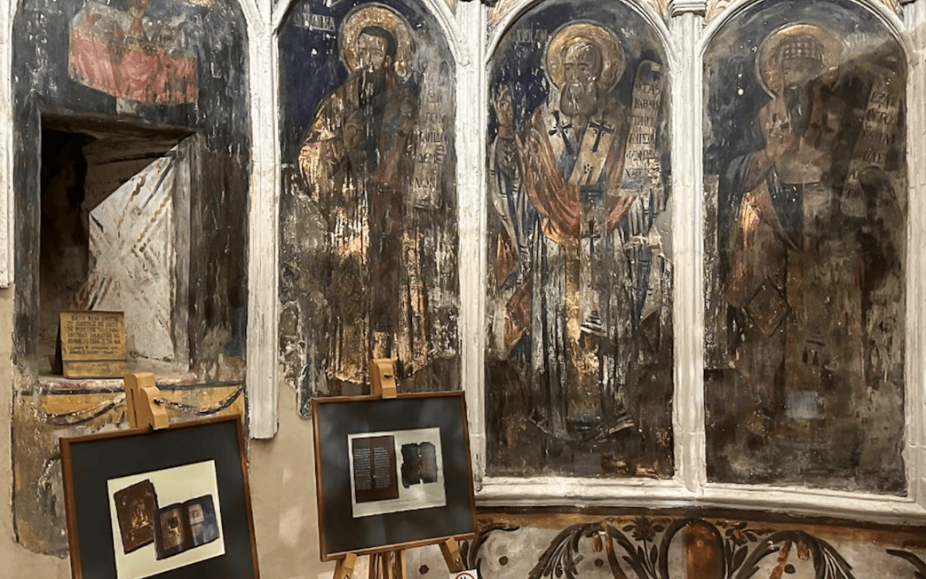 Frescoes and framed artifacts inside Berat Castle, Albania.