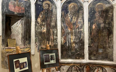 Frescoes and framed artifacts inside Berat Castle, Albania.