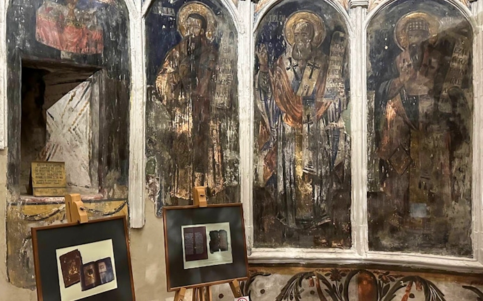 Frescoes and framed artifacts inside Berat Castle, Albania.