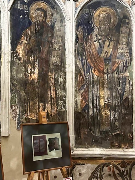 Frescoes and framed artifacts inside Berat Castle, Albania.