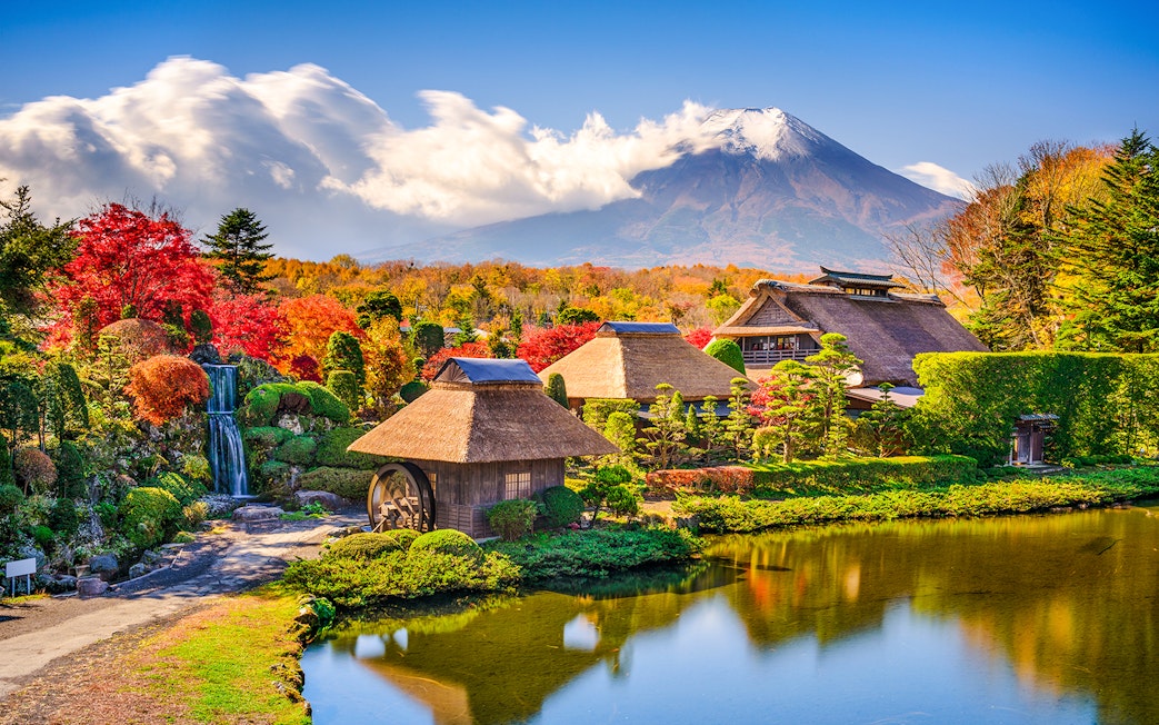 Oshino Hakkai village with traditional thatched roofs and Mt Fuji in the background on a Tokyo tour.