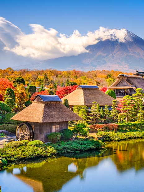 Oshino Hakkai village with traditional thatched roofs and Mt Fuji in the background on a Tokyo tour.