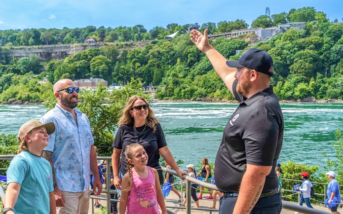 Tourists with guide overlooking Niagara Falls, Canada.