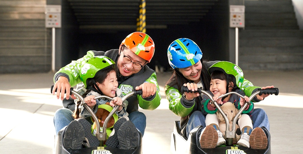 Family enjoying Skyline Luge ride in Busan.