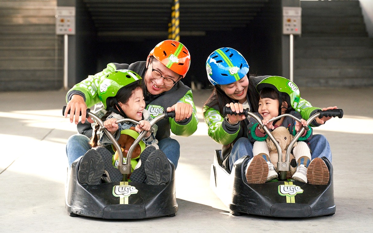 Family enjoying Skyline Luge ride in Busan.