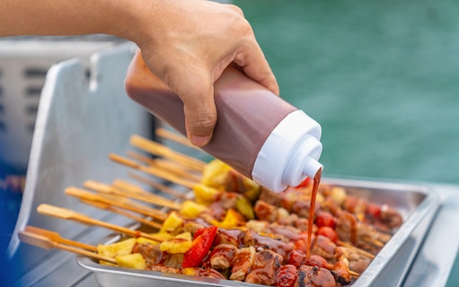 Grilled skewers with sauce on Dragon Sunset Cruise barbecue.
