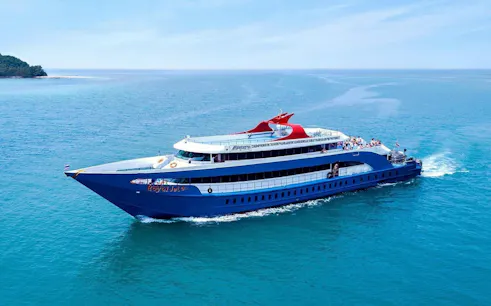 Ferry cruising from Phuket Pier to Phi Phi Islands across clear blue waters.