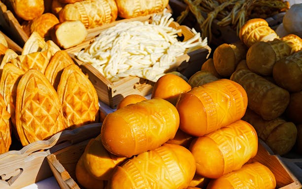 Traditional Oscypek cheese being grilled at a market stall in Zakopane, Poland.