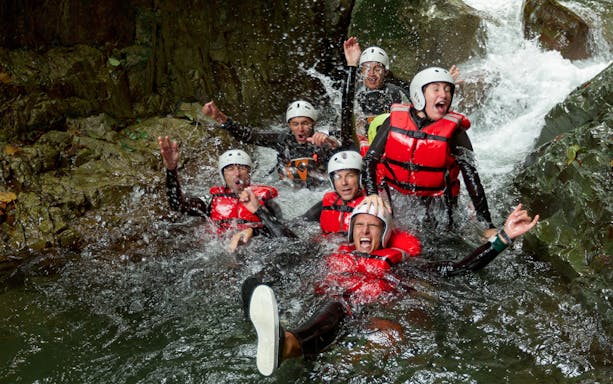 Group canyoning adventure in Braga, Portugal, with participants navigating a waterfall.