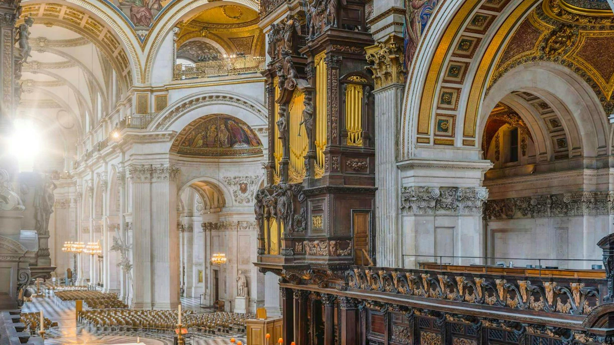 Interiors of St Paul's Cathedral in London showcasing ornate arches and detailed woodwork.