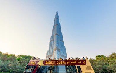 Open-top Big Bus tour in Dubai with Burj Khalifa in the background.