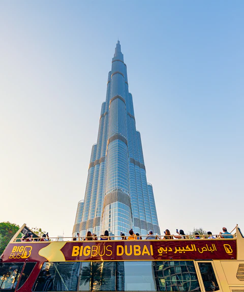 Open-top Big Bus tour in Dubai with Burj Khalifa in the background.