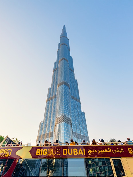 Open-top Big Bus tour in Dubai with Burj Khalifa in the background.