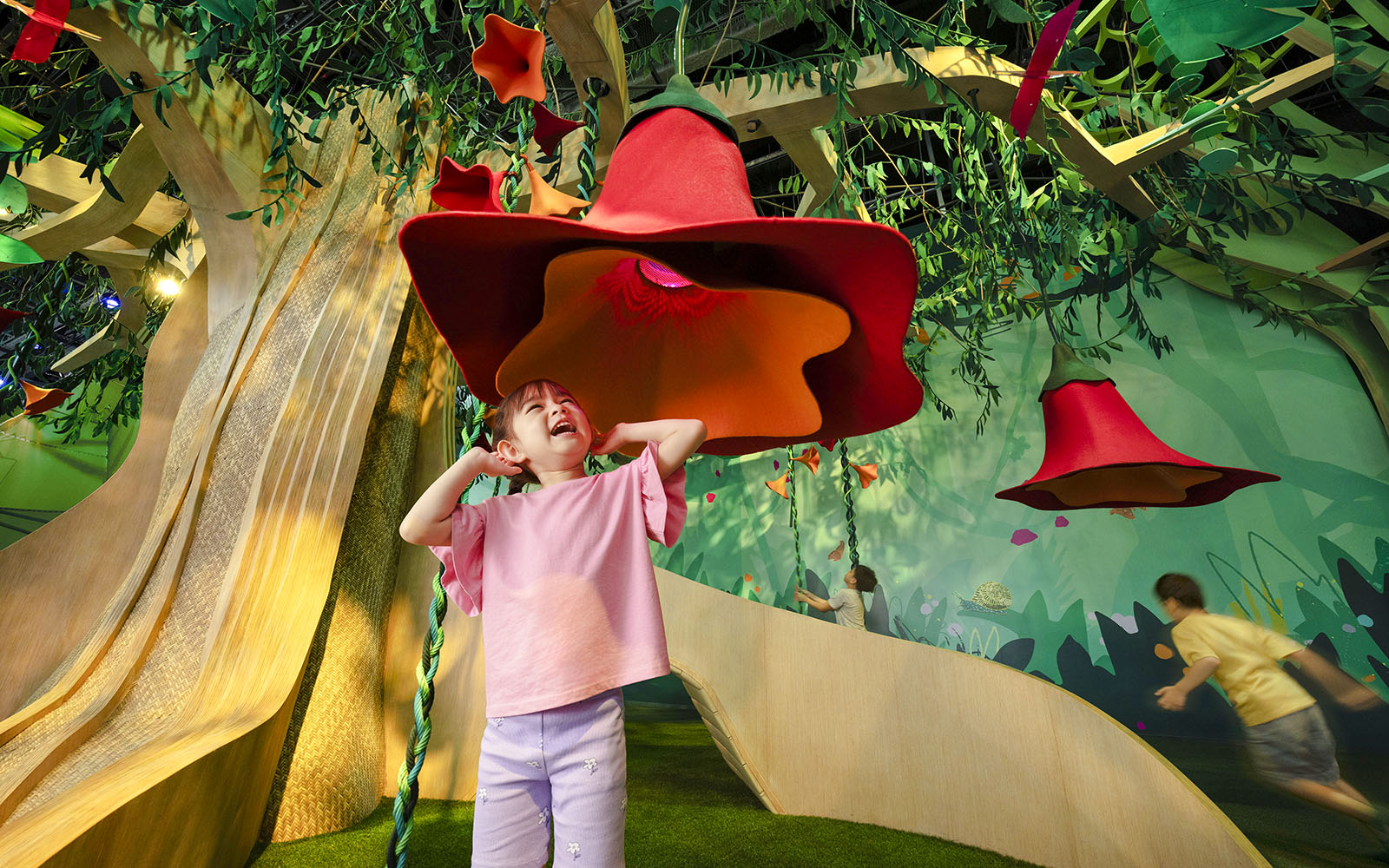 Child exploring interactive SingingTree at Forestland's Curiosity Cove.