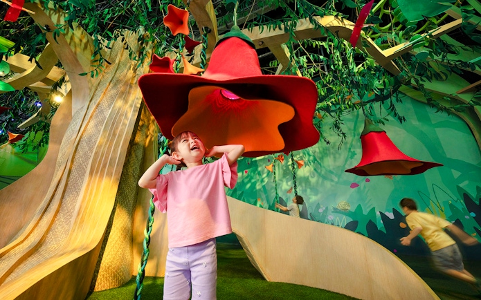 Child exploring interactive SingingTree at Forestland's Curiosity Cove.