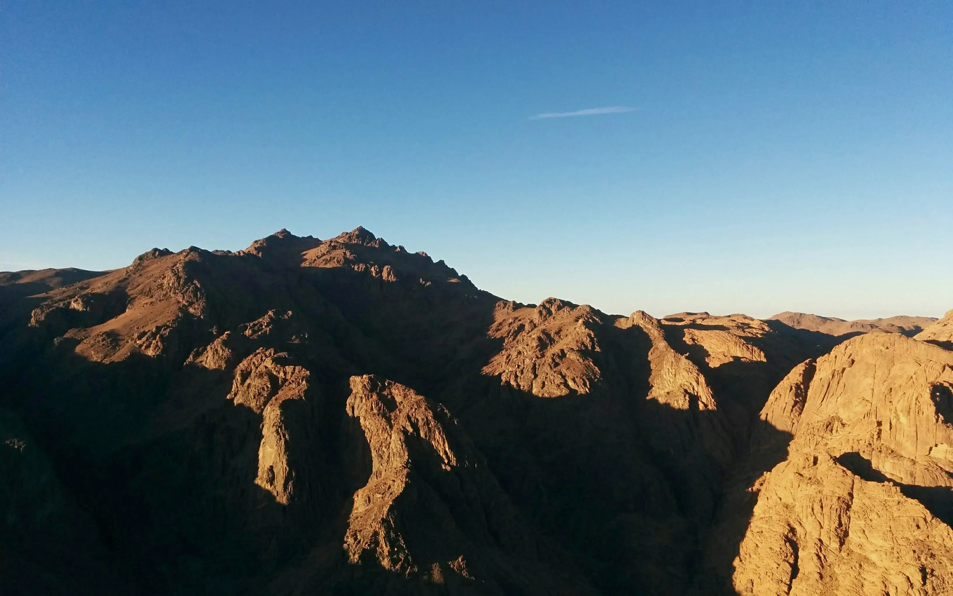 Mount Sinai peaks under clear sky during group tour.