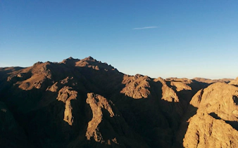 Mount Sinai peaks under clear sky during group tour.