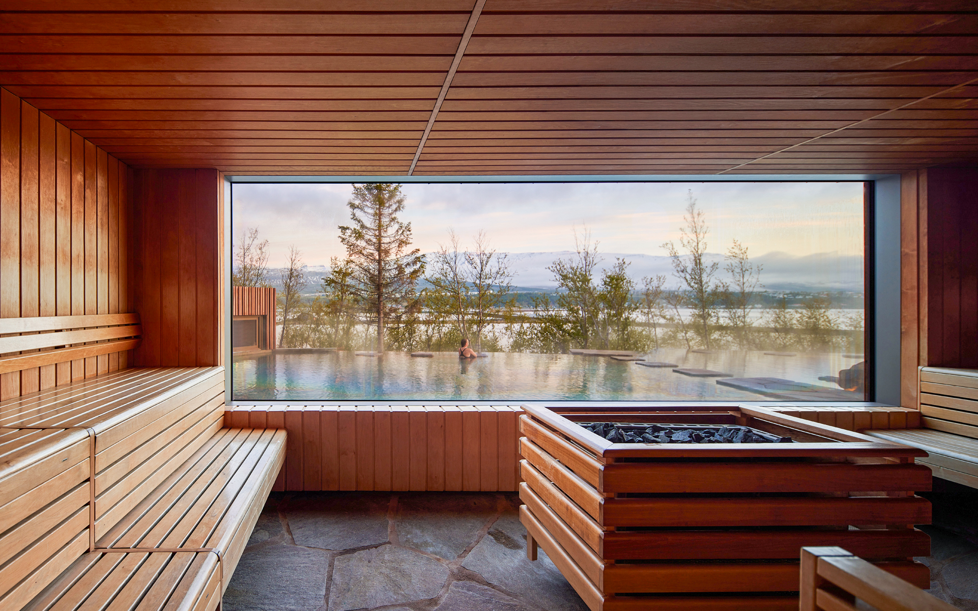 Geothermal spa view from inside Forest Lagoon, Vaðlaskógur forest, Akureyri, North Iceland.