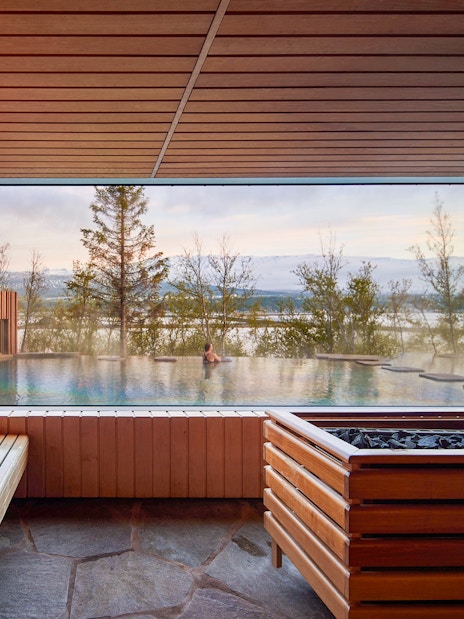 Geothermal spa view from inside Forest Lagoon, Vaðlaskógur forest, Akureyri, North Iceland.