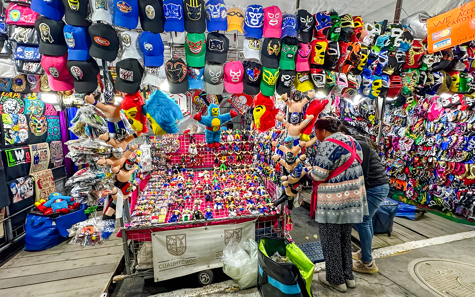Lucha libre shop with colorful masks, hats, and toys on display in Mexico City.