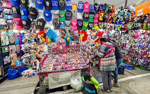 Lucha libre shop with colorful masks, hats, and toys on display in Mexico City.
