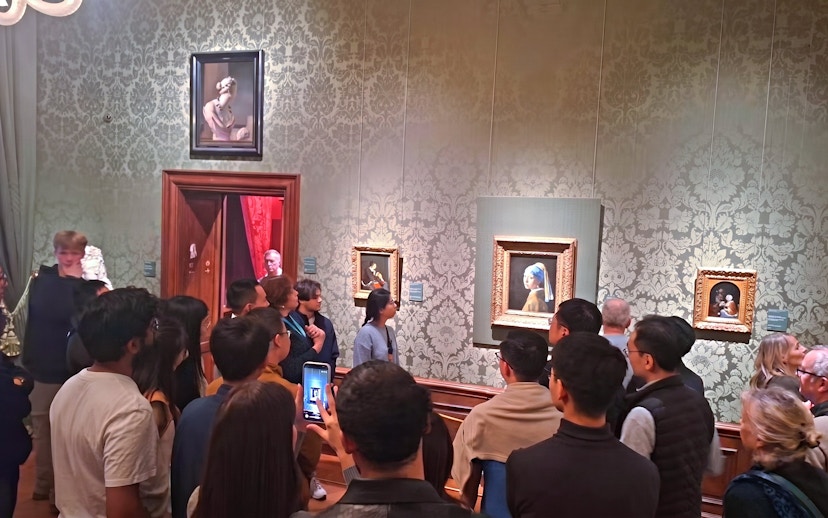Visitors viewing "Girl with a Pearl Earring" at Mauritshuis, The Hague.