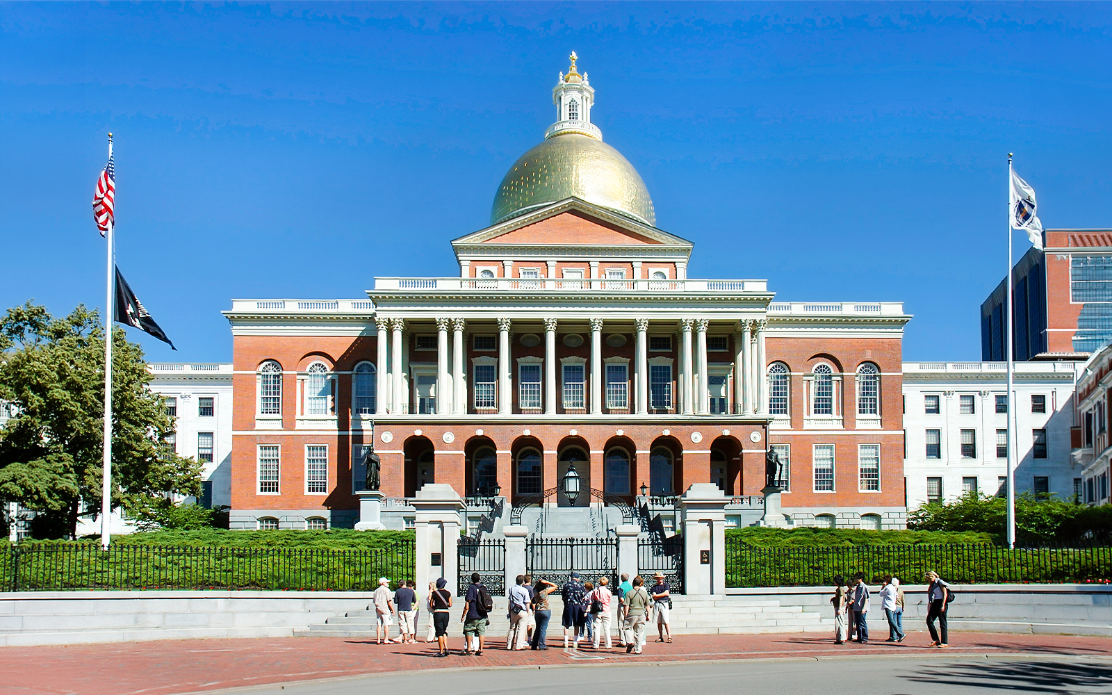 State House in Boston with tourists gathered outside.