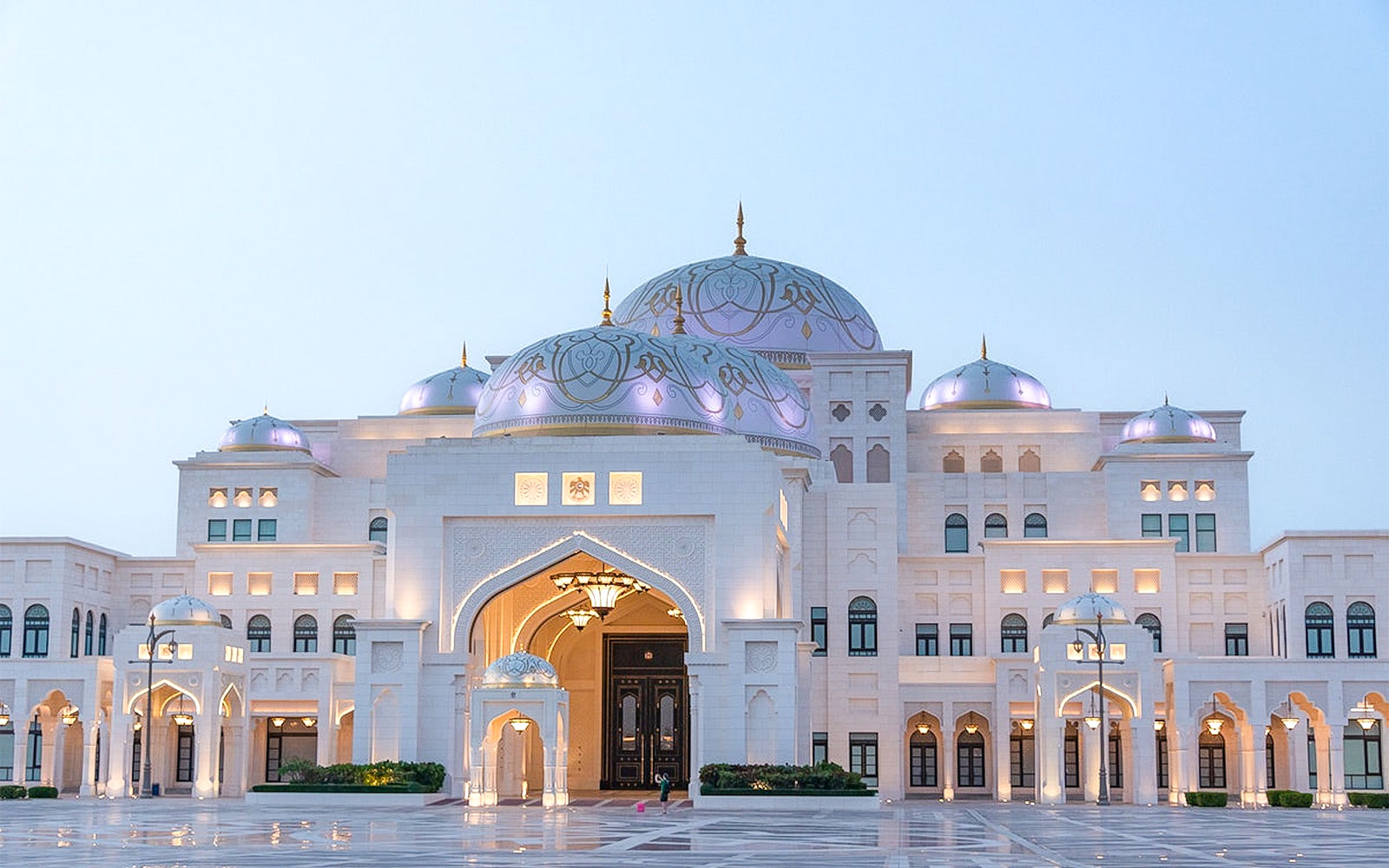 Qasr Al Watan illuminated at dusk in Abu Dhabi with vibrant lights.