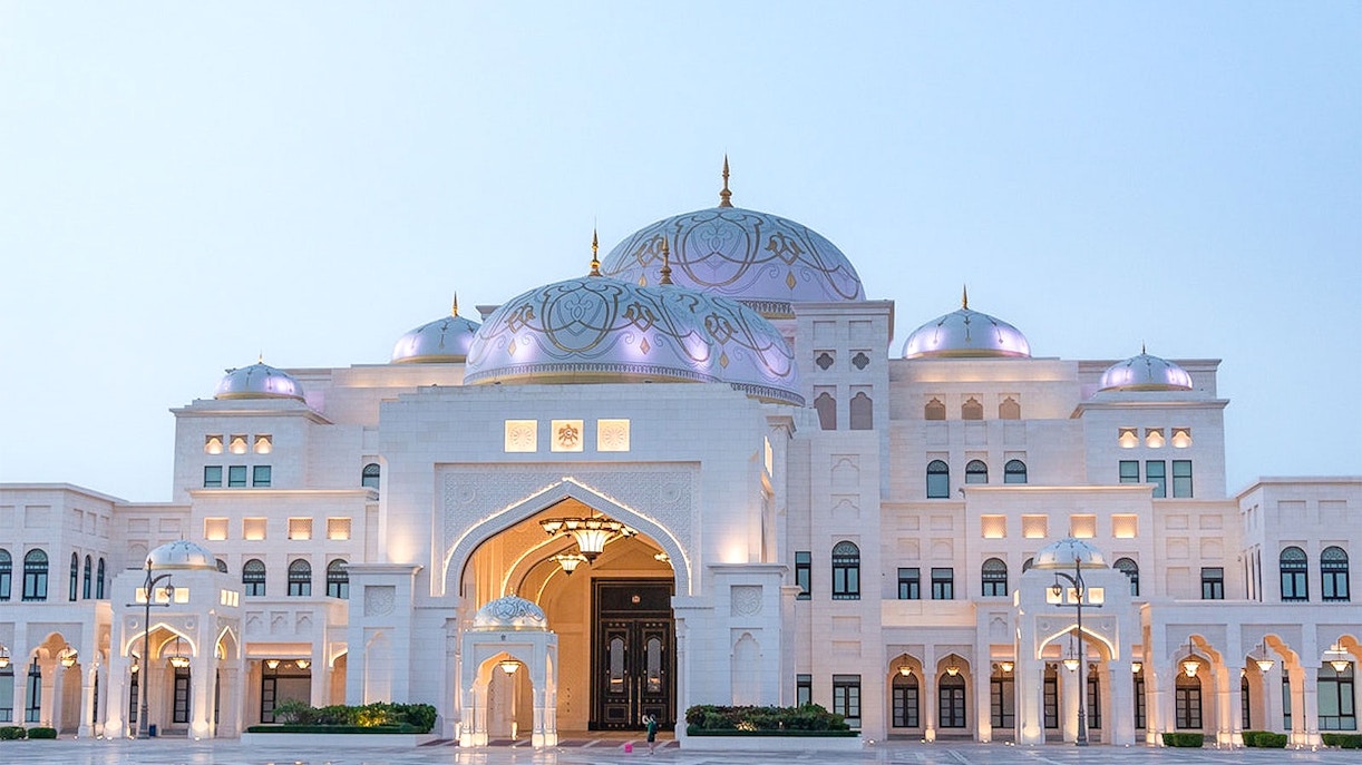 Qasr Al Watan illuminated at dusk in Abu Dhabi with vibrant lights.