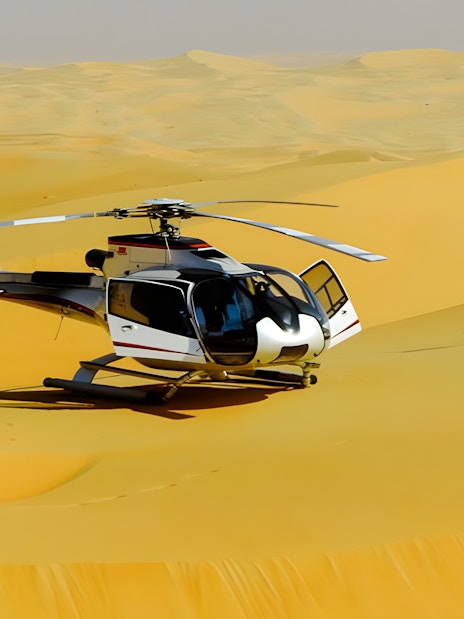 Helicopter on sand dunes in Dubai desert.