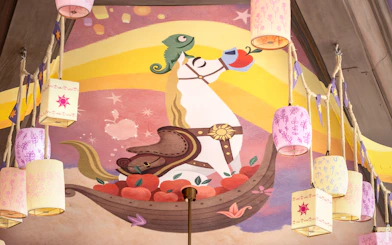Mural of a horse and chameleon with lanterns at Disneyland's World of Frozen, inspired by Tangled.