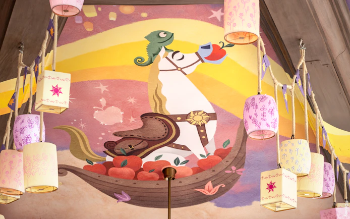 Mural of a horse and chameleon with lanterns at Disneyland's World of Frozen, inspired by Tangled.