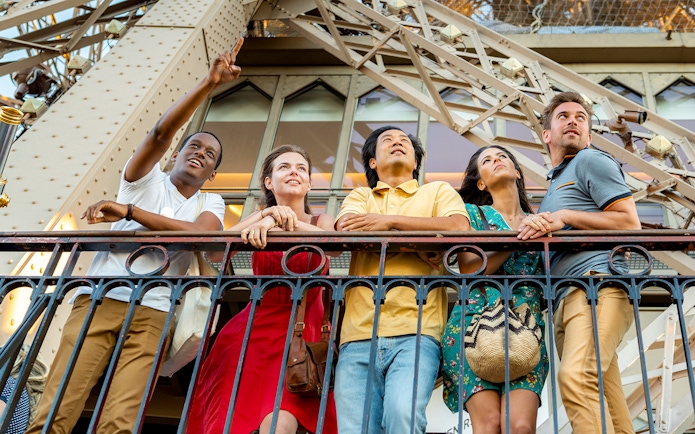 Visitors enjoying the view from the Eiffel Tower's 2nd floor during a Paris city tour.
